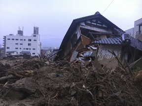 Debris fills a small village following heavy rains Sunday, July 8, 2018, in Kuchita-Minami, Asakita-ku, Hiroshima, Japan. Searches continued Sunday night for dozens of victims still missing from the heavy rainfall that hammered southern Japan for the third straight day.