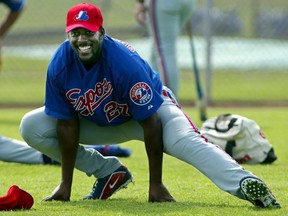 Vladimir Guerrero smiles while stretching during Expos spring training camp in Melbourne, Fla., on Feb. 20, 2003.