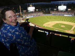 This Sunday, April 17, 2016 photo shows Sue Manning, an editor in the Los Angeles bureau of The Associated Press during a game at Los Angeles Dodger Stadium. Manning, an Associated Press editor who for decades delivered stories of Southern California to the world, has died at age 71. Manning's brother Daniel Manning says police found her dead at her home in Glendale, Calif., on Sunday, July 15, 2018, after family members couldn't reach her.