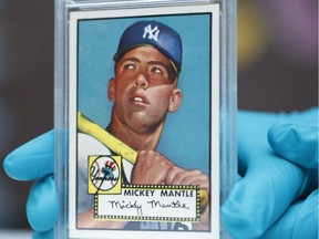 The "Holy Grail" of baseball cards, a 1952 Topps Mickey Mantle that is valued at more than $10 million, is put on display as part of baseball memorabilia exhibit at the Colorado History Museum Monday, July 16, 2018, in Denver. The pristine card, one of three known to still be in existence, is owned by Denver lawyer Marshall Fogell.