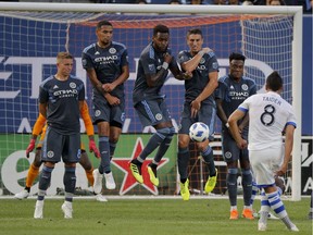New York City FC players block a free kick by Montreal Impact midfielder Saphir Taider (8) during the first half of an MLS soccer match Wednesday, July 11, 2018, in New York.