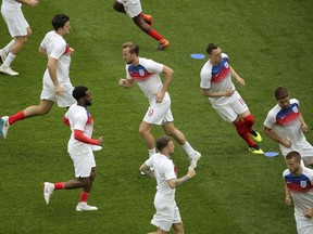 English soccer players warm up before a 2018 World Cup match. There’s a fine line between getting the body primed for a game and going into the event already feeling fatigued.