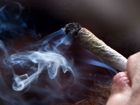 A young man smokes a marijuana joint during a rally in downtown Vancouver, B.C., on Wednesday April 20, 2011. People who break Saskatchewan's new recreational marijuana laws could face fines ranging from $200 to more than $2,000, depending on the charge.