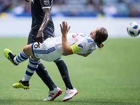 Montreal Impact's Samuel Piette, front, and Vancouver Whitecaps' Kei Kamara collide during first half semifinal Canadian Championship soccer action in Vancouver on Wednesday July 25, 2018.