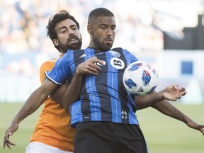 Houston Dynamo's Kevin Garcia, left, challenges Montreal Impact's Anthony Jackson-Hamel during first half MLS soccer action in Montreal on June 2, 2018.