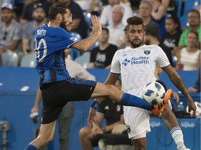 Montreal Impact's Ignacio Piatti and San Jose Earthquakes' Anibal Godoy battle for the ball during first half MLS action in Montreal on Saturday, July 14, 2018.