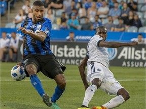 Montreal Impact's Anthony Jackson-Hamel, left, tries to control the ball as Vancouver Whitecaps' Ali Ghazal fails the stop during first half Canadian Championship action, on July 18, 2018.