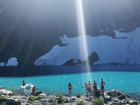 Hikers cool off in the icy waters of British Columbia's Berg Lake.