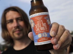 Samuli Huuhtanen, CEO of Finnish beer brewery Rock Paper Scissors displays a beer bottle labeled with cartoon caricatures depicting Russian President Vladimir Putin and U.S President Donald Trump, during an interview with the Associated Press in Helsinki, Saturday, July 14, 2018. A small Finnish craft brewery is paying a humorous tribute to the July 16 Helsinki summit by a limited-edition lager beer depicting cartoon U.S. and Russian presidents on its label with a text urging Donald Trump and Vladimir Putin to settle things "like adults".