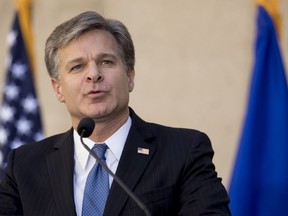 FILE - In this Sept. 28, 2017, file photo, FBI Director Chris Wray speaks at his installation ceremony at the FBI Building in Washington. Wray is dismissing Russia President Vladimir Putin's denial of election meddling. Wray said July 18, 2018, that he stands behind the U.S. intelligence agencies' assessment that Moscow did intervene. And he says Russia continues to use fake news and propaganda to stir up divisiveness in American society.