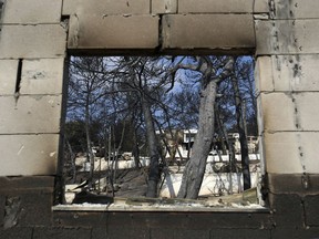 A burned family summer camp is seen in Mati, east of Athens, Wednesday, July 25, 2018. Rescue crews were searching through charred homes and cars for the missing after wildfires decimated seaside areas near the Greek capital, killing at least 74 people and sending thousands fleeing.