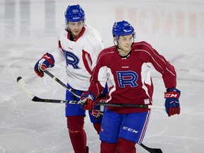 Laval Rocket left wing Yannick Veilleux, left, and Laval Rocket right wing Antoine Waked listen to the coach during a team practice in Montreal on Wednesday January 17, 2018.