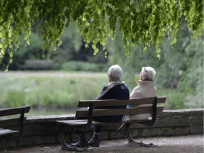 In this May 14, 2014 file photo, an elderly couple sits on a bench in a park in Gelsenkirchen, Germany.
