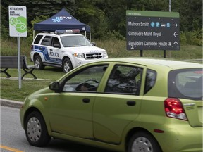A car makes is way past Montreal police at Remembrance and Camillien-Houde near the Mount-Royal cemetery on Friday August 3, 2018.