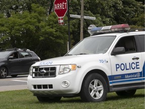 Police were watching the intersection of Remembrance Rd. and Camillien-Houde Way on Mount Royal on Friday, Aug. 3. Landscape architect Frederick Law Olmsted intended for a road to reach the mountain's summit so the sick, the elderly and families could enjoy the great outdoors, Allison Hanes writes.