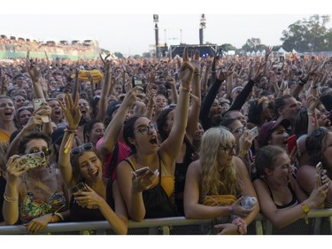 Crowd cheers on Post Malone as he performs at Osheaga in Montreal, Sunday, August 5, 2018.