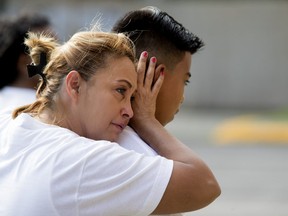 MONTREAL, QUE.: AUGUST 9, 2018-- Lilian Maribel Madrid Antunes comforts her grandson, Deyui Villanueva during a memorial to mark the 10th anniversary of Fredy Villanueva's death. The memorial was held in Montreal on Thursday August 9, 2018. (Allen McInnis / MONTREAL GAZETTE) ORG XMIT: 61190