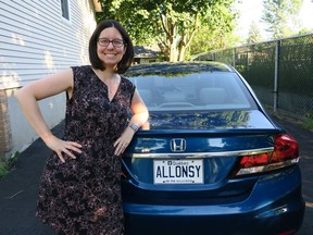 Vickie Louwet stands next to her ALL0NSY licence plate, which is among the first to be released in Quebec.