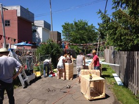 Lachine residents work to beautify one of the borough's alleyways. The borough has launched the Programme de ruelles communautaires which will distribute grants to help residents continue their work.