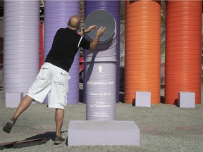 A man tries to generate some sound in the Wind Instrument, a new interactive installation next to the St-Laurent métro station on Thursday, Aug. 16, 2018.