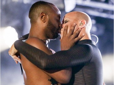 Fischerspooner, right, kisses one of his dancers during his performance on the main stage at Pride festivities in Montreal on Friday, August 17, 2018.