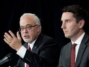 Quebec Finance Minister Carlos J. Leitão, left, and Transport Minister André Fortin announce details of the government's compensation package for the province's taxi drivers during a press conference in Montreal on Friday, August 17, 2018.