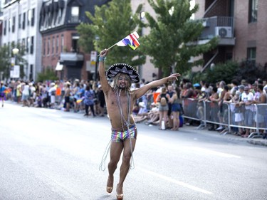 Participants dance as they march in the Montreal Pride parade on Aug. 19, 2018.