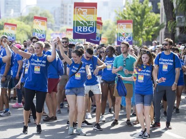 Participants dance as they march in the Montreal Pride parade on Aug. 19, 2018.