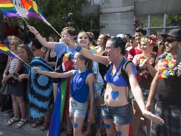 Spectators Vicki Taylor  (right) from Cowansville brought her 13-year-old daughter, Mila Jane Taylor, to her first Pride Parade in Montreal on Aug. 19, 2018.