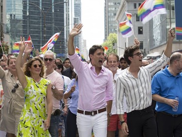Prime Minister Justin Trudeau (centre), his wife Sophie Grégoire Trudeau and Queer Eye star Antoni Porowski march in the Montreal Pride Parade on Aug. 19, 2018.