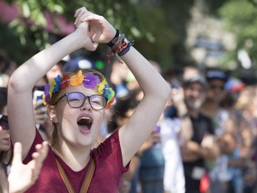 Spectators cheer as they watch the Pride Parade in Montreal on Aug. 19, 2018.