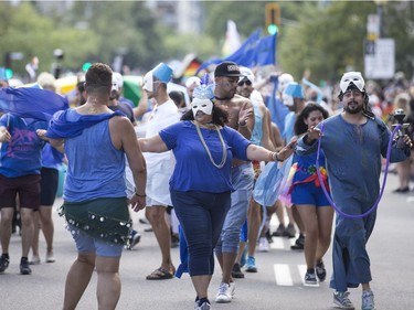 Participants dance as they march in the Montreal Pride Parade on Aug. 19, 2018.