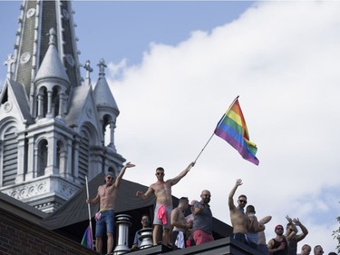 Spectators cheer as they watch the Pride parade in Montreal on Aug. 19, 2018.