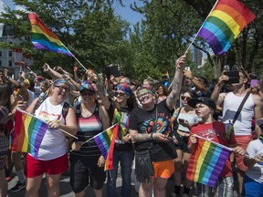 Onlookers dressed to enjoy the day watch last year's Pride parade along Boulevard René-Lévesque in Montreal, on Sunday, August 20, 2017.