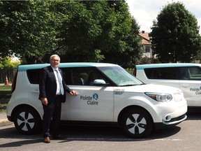 Pointe-Claire Mayor John Belvedere poses with one of the city's six new electric vehicles.