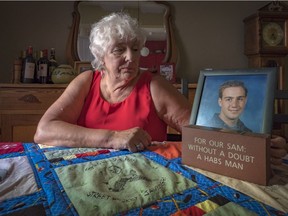 Janet Torge holds a photo of son Sam Lazarus on a facsimile of the brick at the Bell Centre's Centennial Plaza purchased in the Habs' fan's memory. The annual fundraiser in his name is Aug. 25, 2018.  (Dave Sidaway / MONTREAL GAZETTE)