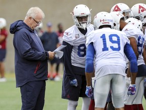 Alouettes head coach Mike Sherman consults his notes during practice last week. After starting five different quarterbacks this season, Sherman finally believes his team has two who can help his team win.
