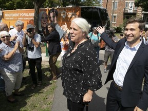 Québec solidaire spokesperson Manon Masse and Gabriel Nadeau-Dubois show off the new campaign bus in the riding of Laurier-Dorion on Thursday, Aug.23, 2018, the first day of the provincial election campaign.