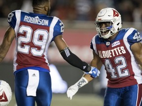 Montreal Alouettes defensive-lineman Jean-Samuel Blanc, right, and defensive-back Jermaine Robinson celebrate after beating the Toronto Argonauts 25-22 in Montreal on Aug. 24, 2018.