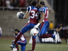 Montreal Alouettes linebacker Glenn Love and Montreal Alouettes linebacker Henoc Muamba, right, celebrate after beating the Toronto Argonauts 25-22 during CFL action in Montreal on Friday August 24, 2018.