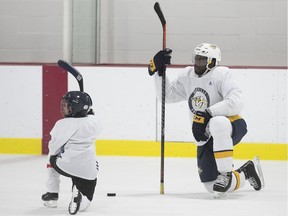 Nashville Predator's P.K. Subban rests on the ice with young kids at his hockey clinic in Pierrefonds on Saturday, August 25, 2018.
