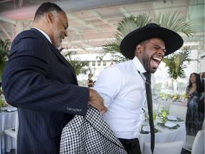 P.K. Subban gets helped into his jacket by Wayne Yearwood before his fundraising dinner for his charitable foundation in Montreal on Thursday.