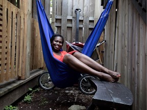 Shannon Thomas relaxes in a hammock in the private yard attached to her cottage apartment in Point St-Charles.