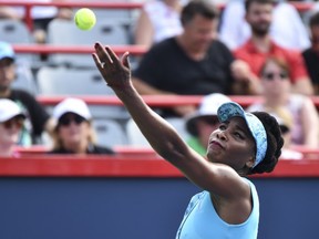 Venus Williams serves against Caroline Dolehide during day one of the Rogers Cup at IGA Stadium on August 6, 2018 in Montreal.