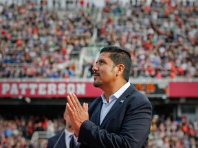 Former Montreal Alouettes quarterback Anthony Calvillo thanks the crowd for their ovation during ceremony to retire his No. 13 at Molson Stadium in Montreal on Oct. 13, 2014, during halftime of a game against the Saskatchewan Roughriders.
