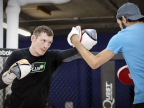 UFC star Joe Duffy works on his boxing skills with trainer Hercules Kyvelos at Montreal's Tristar Gym in October 2017. Doing a workout with a trainer or friend helps give new exercisers motivation and accountability.