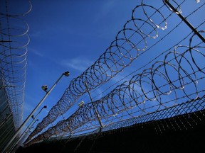 Barbed wire at the top of a prison fence.