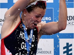 HAMBURG, GERMANY - JULY 18:  (L-R) Vicky Holland of Great Britain, Gwen Jorgensen of the United States of America and Non Stanford of Great Britain celebrate after the ITU Women's Elite Sprint race during the ITU World Triathlon Hamburg on July 18, 2015 in Hamburg, Germany.