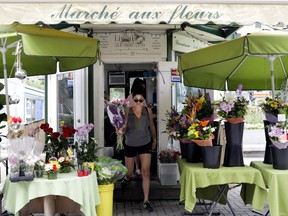 Emilie Huot leaves Lioudmila Zoueva's flower stand in Phillips Square. “I thought I was settled, but now I have to restart everything,” Zoueva says.