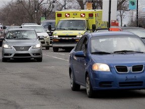 An ambulance makes its way through traffic.